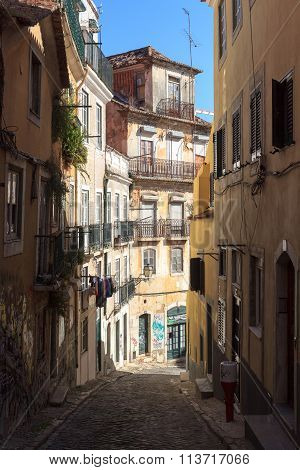 Typical small Alley with sunshine in Lisbon, Portugal