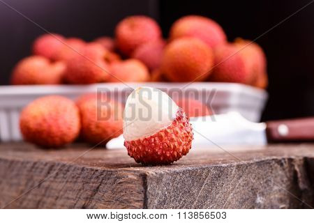Lychee Fruit, Which Is Called Chinese Plum, Is On The Dark Board And In Basket.