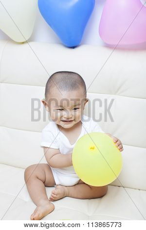 Chinese baby boy and colorful balloons shot in Beijing China
