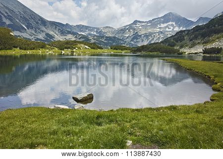 Amazing Landscape of  Banderishki Chukar peak and reflection in Muratovo lake, Pirin Mountain