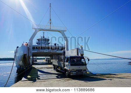 MENUMBOK, SABAH - JAN 6, 2016: Ferry with vehicles on board in the morning,carries passengers.