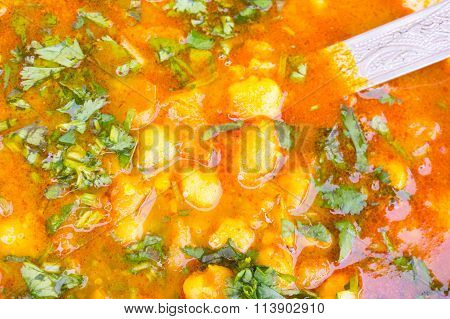 Indian potato gravy dish garnished with coriander
