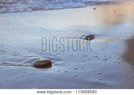 stones on the beach at sunset in Sri Lanka