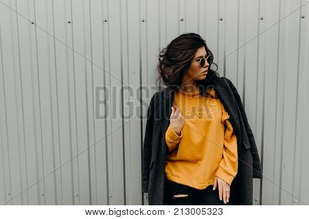 Portrait Of Stylish Modern Young Curly Woman In Coat Sunglasses