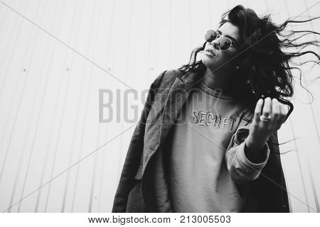 Portrait Of Stylish Modern Young Curly Woman In Coat Sunglasses