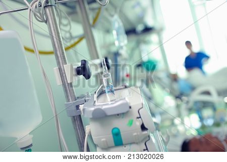 Comatose patient in the intensive care unit under the supervision of the nurse.