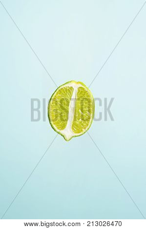 slice of lime isolated on blue background
