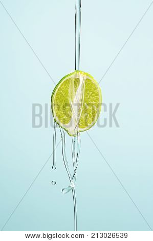 The lime oil jet isolated on blue studio background