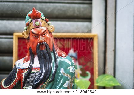 Statue of popular Chinese god Guan Yu at a street shrine in Hong Kong