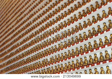 SHATIN HONG KONG - SEPT 15 2013 - Golden Buddha statues in the main hall at the Ten Thousand Buddhas Monastery Hong Kong