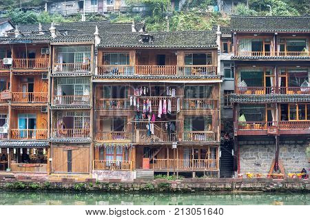 FENGHUNG, CHINA - NOV 11, 2014 - Stilt houses on the Tuojiang River at Fenghuang ancient town, Hunan Province, China