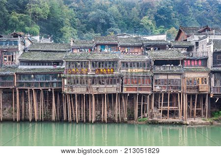 FENGHUNG CHINA - NOV 12 2014 - Traditional stilt houses on the Tuojiang River Fenghuang China