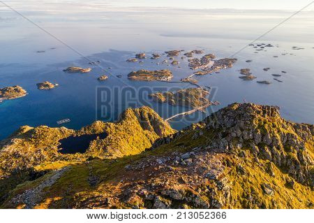 Top of mount Festvagtinden with views over the village of Henningsvaer. Henningsvaer is a fishing village located on several small islands in the Lofoten archipelago in Norway.
