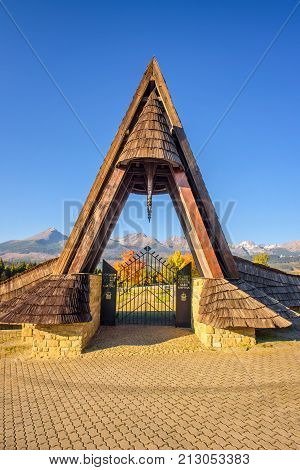 VAZEC, SLOVAKA - OCTOBER 1, 2017 : Entry gate of the german military cemetery in autumn with High Tatra mountains in the background.