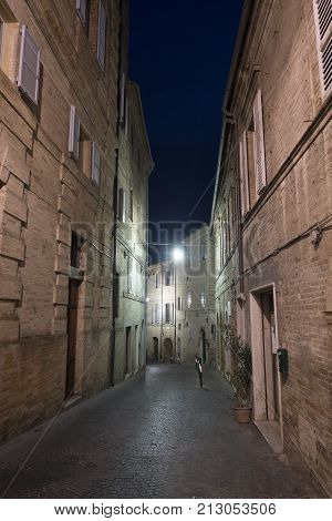 Fermo (Marches Italy): historic buildings along an old typical street at evening.