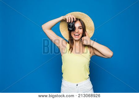 Close Up Photo Of Woman In Hat On Blue Taking A Photo With Digital Camera