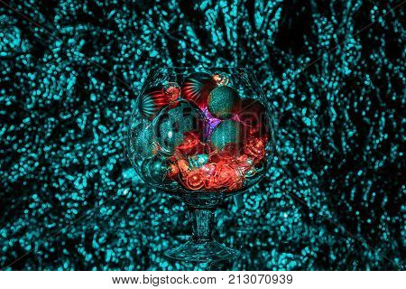 Decorative vase with cut in the form of stars on the background light Christmas garland