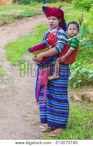 INLE LAKE MYANMAR - SEP 07 : Intha tribe woman with her child in Inle lake Myanmar on September 07 2017 The Intha people live along the Inle lake shores and on the lake itself