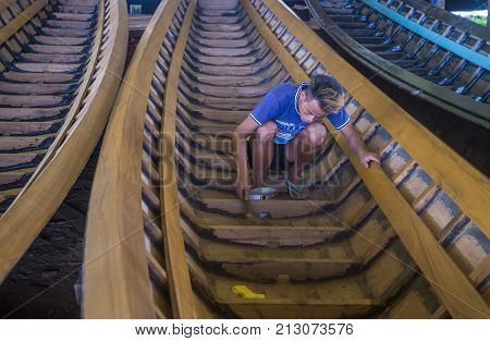INLE LAKE MYANMAR - SEP 07 : A Burmese man building a boat in Inle lake Myanmar on September 07 2017 inle Lake is a freshwater lake located in Shan state