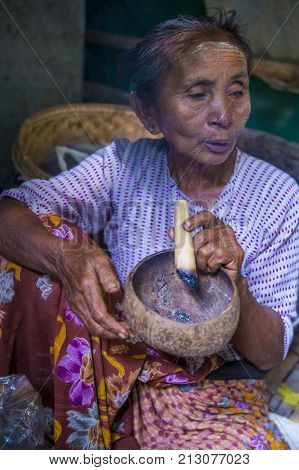 BAGAN MYANMAR- SEP 04 : Woman smoking a cheroot cigar in market in bagan Myanmar on September 04 2017. Cheroot is a cigar made by dried fruits and little bit of tobacco