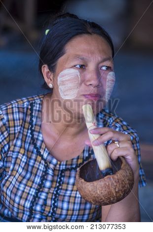 BAGAN MYANMAR- SEP 04 : Woman smoking a cheroot cigar in market in bagan Myanmar on September 04 2017. Cheroot is a cigar made by dried fruits and little bit of tobacco