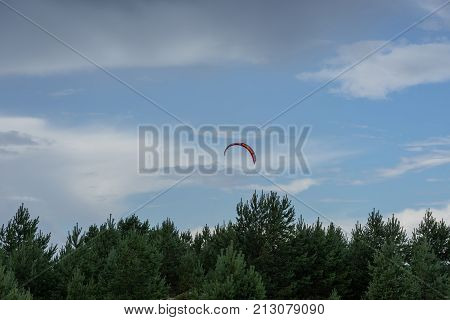 A kite surfer rides on the sea. Kites in the sky. Kite Boarding extreme sport on Mohni small island in Estonia Europe.