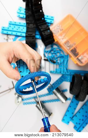 Assemble of DIY kit close up view. Hands making RC model