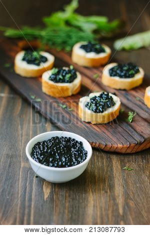 Black caviar over the wooden kitchen table.