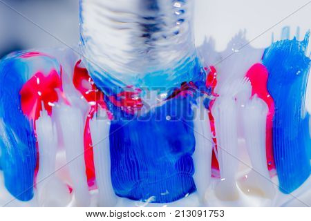 View of colorful tooth brush under water fall.