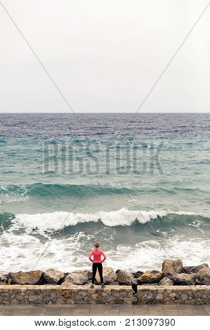 Runner On City Street Looking At Inspiring Sea View