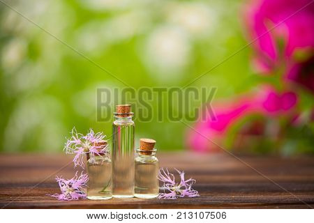 Essence Of Flowers On Table In Beautiful Glass Jar