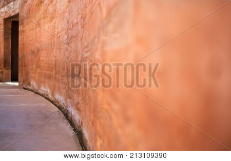 Brown clay blur wall beside of walkway