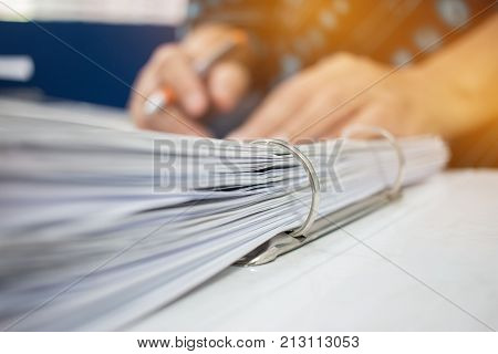 Hands business checking documents management folders in office for Annual Report files on Abstract blurred photo of businessman hands working with laptop computer. business busy concept