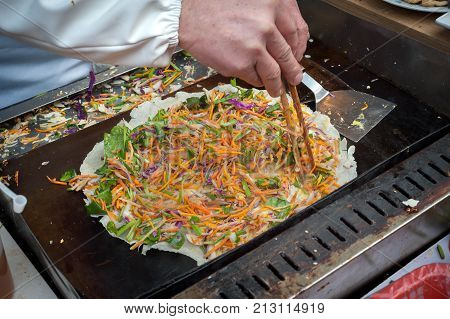 Chinese Jianbing pancake being prepared at a Shanghai street market
