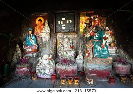 HONG KONG - DEC 18, 2013 - Collection of Chinese gods in an outdoor shrine, Hong Kong