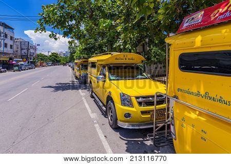 CHIANG MAI THAILAND - JULY 27: These are yellow taxis which are used for to collect groups of people around the city and as private taxis on July 27 2017 in Chiang Mai