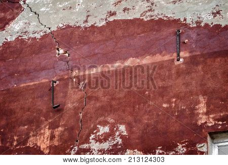 Fragment of the wall of a very old apartment house. Old architecture
