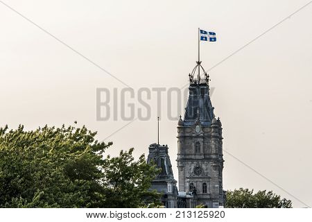 QUEBEC CITY CANADA The blue and white flag flies proudly on top of the impressive clock tower of the parliament building of the national assembly