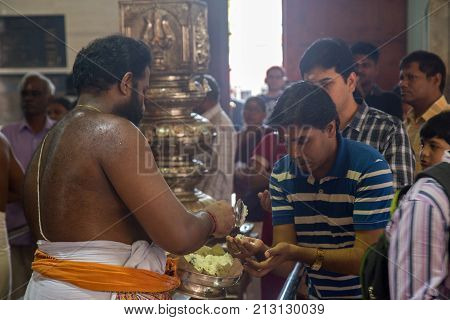 Singapore, Singapore - January 31, 2015: Devotees at a ceremeny inside Sri Srinivasa Perumal temple in Little India distrcit