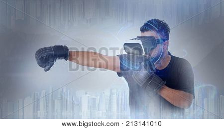 Young Guy in black t shirt looking through VR (Virtual Reality) glasses - Boxing gloves