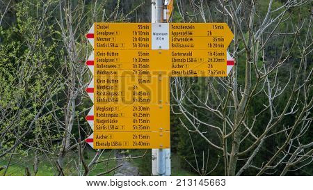 Seealpsee Switzerland - May 2017: Yellow sign post with mountains in the Swiss Alps.