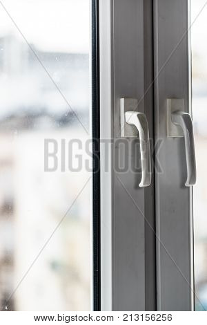 Detailed close up of dirty window frame made of plastic and hadle.