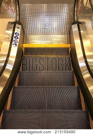 Escalator at shopping mall,Moving down staircase  electric escalator.Close up shot with metal line steel.