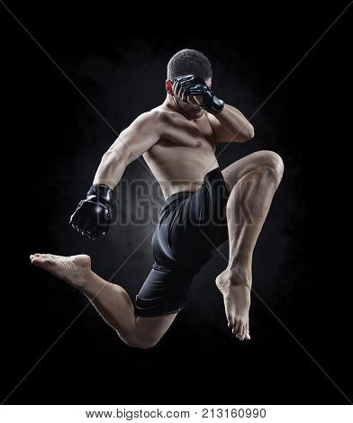mmamake fighter performing a knee kick in the air isolated
