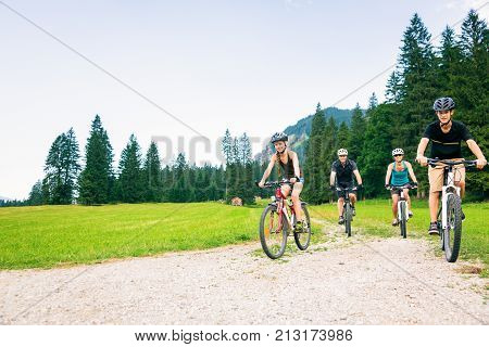 family of four cycling by the vilsalpsee in austria