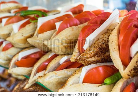 tomato cheese between bread with Sesame and pepper kumru