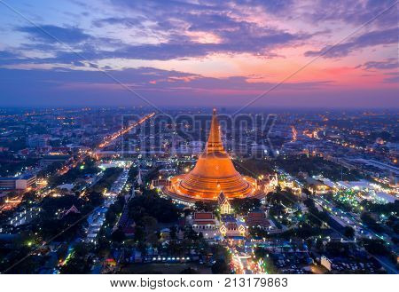 Large golden pagoda Located in the community at sunset Phra Pathom Chedi Nakhon Pathom Thailand .
