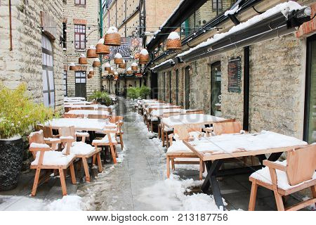 TALLINN, ESTONIA - OCTOBER 28, 2017: Rotermann City Quarter with Restaurant Terrace Covered in Snow. Newly Opened Cosy Urban Environment in Historical Location. Shopping District and Hang Out Place.