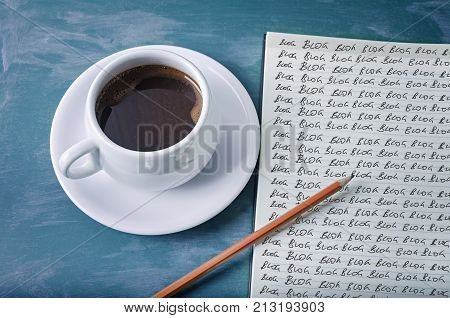 Blog blog blog- blogging concept on a notebook with cup of espresso coffee