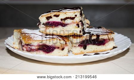 Homemade pastry apple pie pies bakery products on dark wooden kitchen table with raisins, blueberry and apples. Traditional dessert on Independence Day. Flat lay food background. Top view